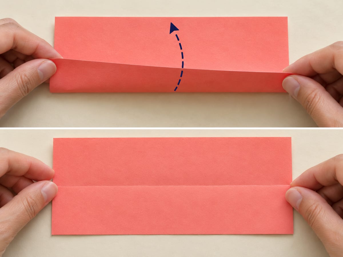 origami star step 1: place the rectangle horizontally; fold the long edges together, crease, and reopen, hands visible